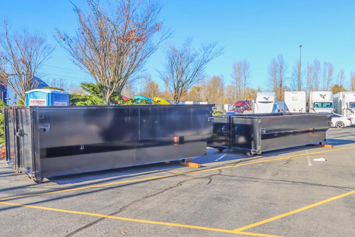 Professional dumpster rental service with roll-off container on residential driveway in Alafaya